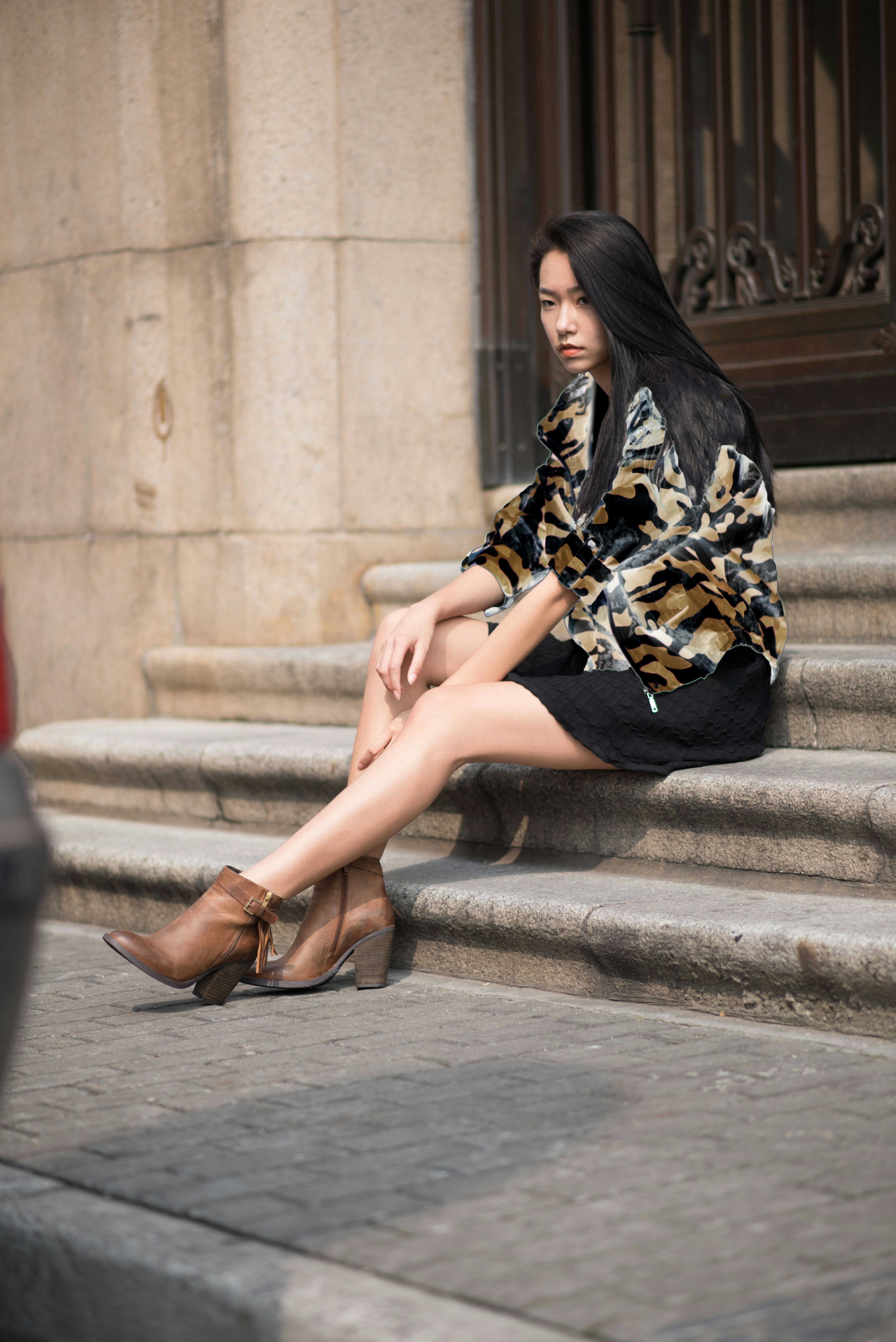 Woman in black dress sitting on concrete stairs photo – Free Grey Image ...
