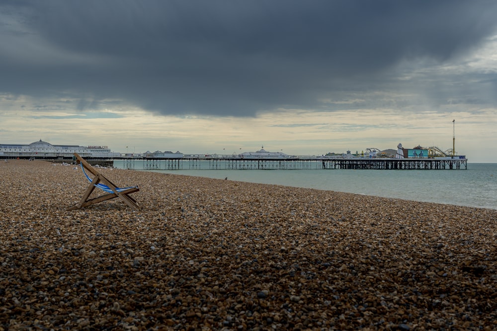 brown wooden beach dock on sea under gray clouds