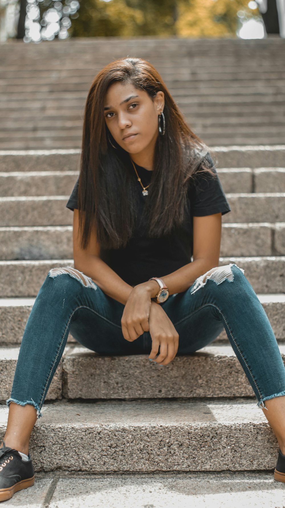 Woman in black shirt and blue denim jeans sitting on brown concrete stairs  photo – Free Dominican republic Image on Unsplash