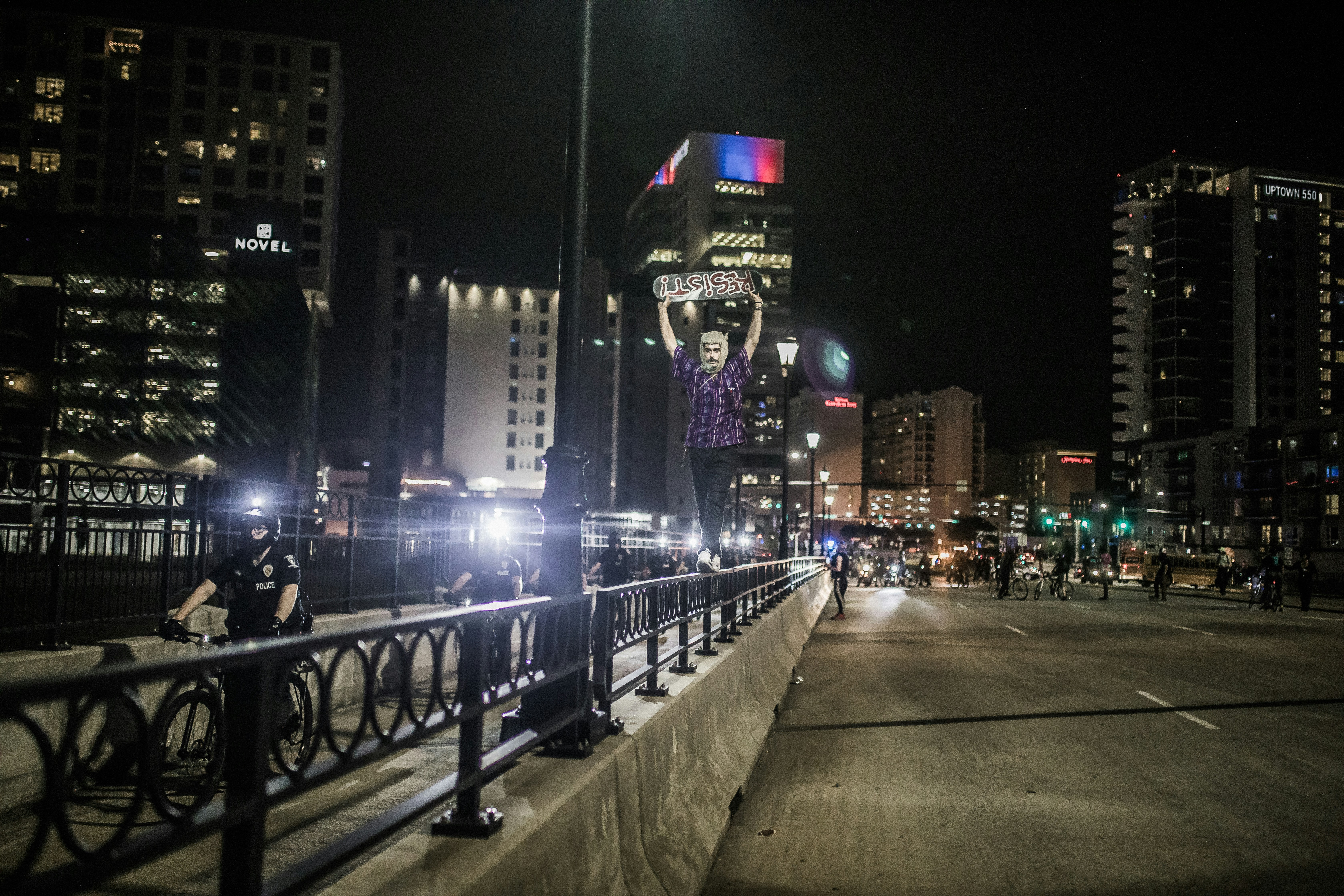 black metal fence near city buildings during night time