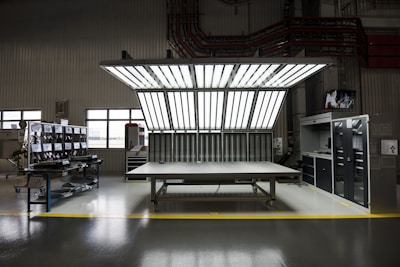 Wide shot of herofacility’s bright, open main workspace with natural light streaming through large windows.