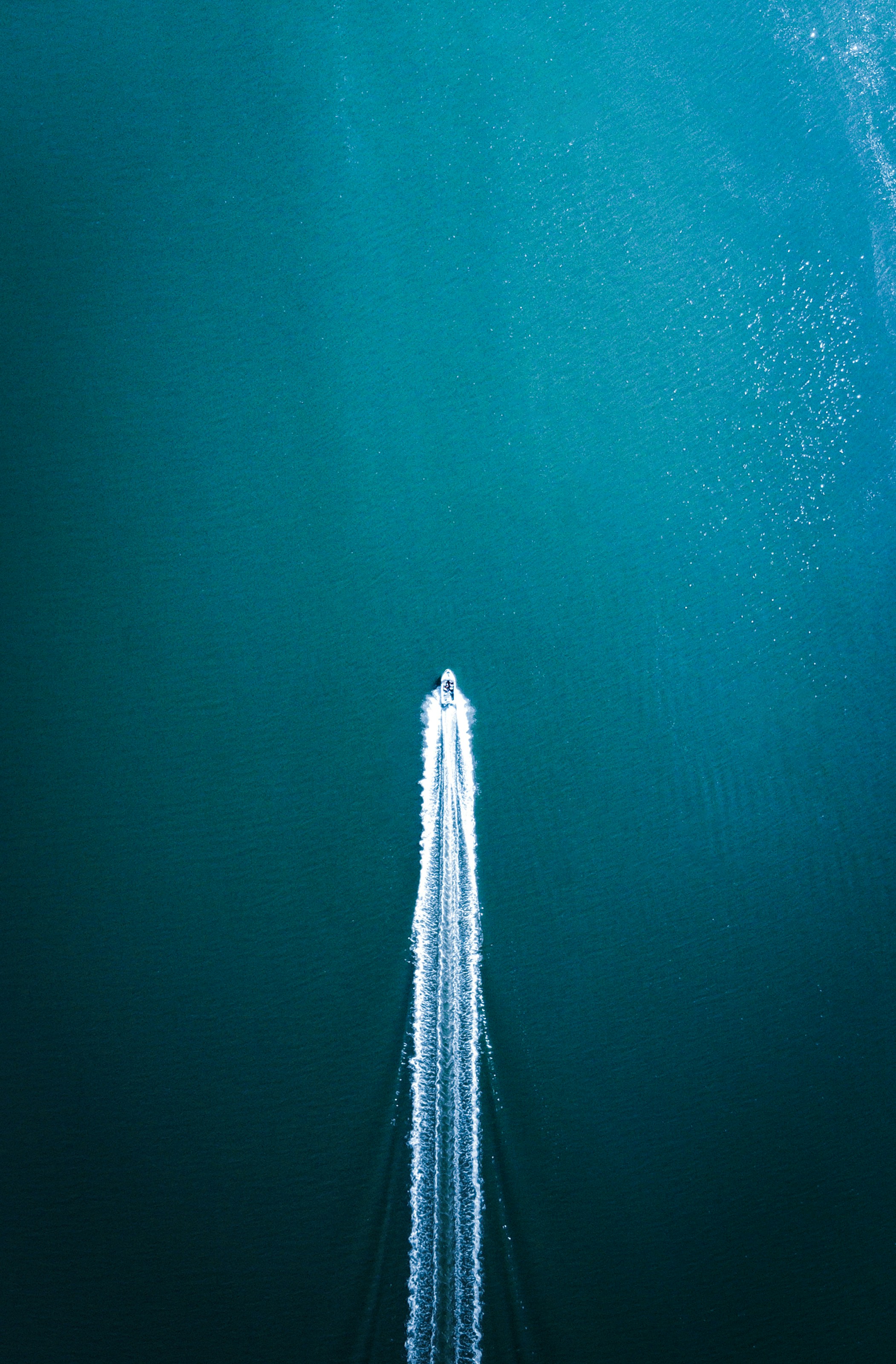white and black boat on blue water