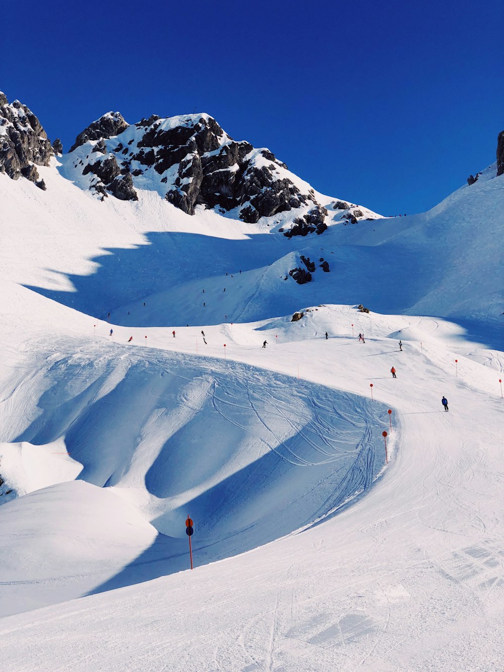 person walking on snow covered mountain during daytime