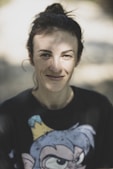 woman in black crew neck shirt smiling