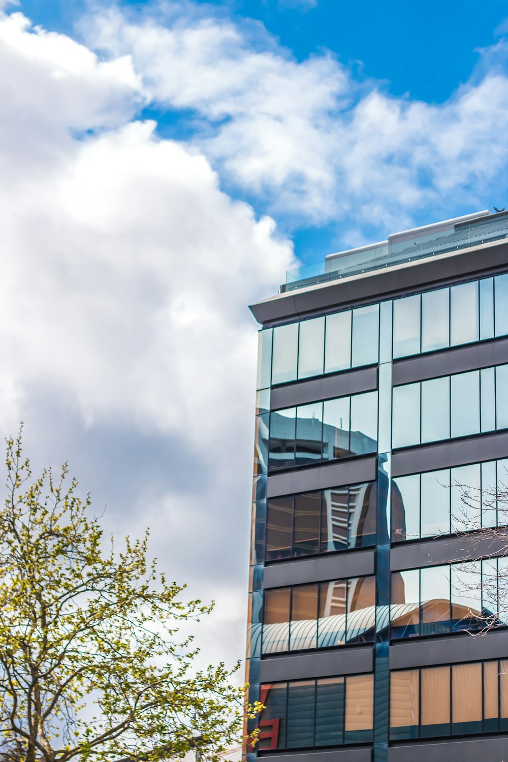 white and black concrete building under white clouds during daytime