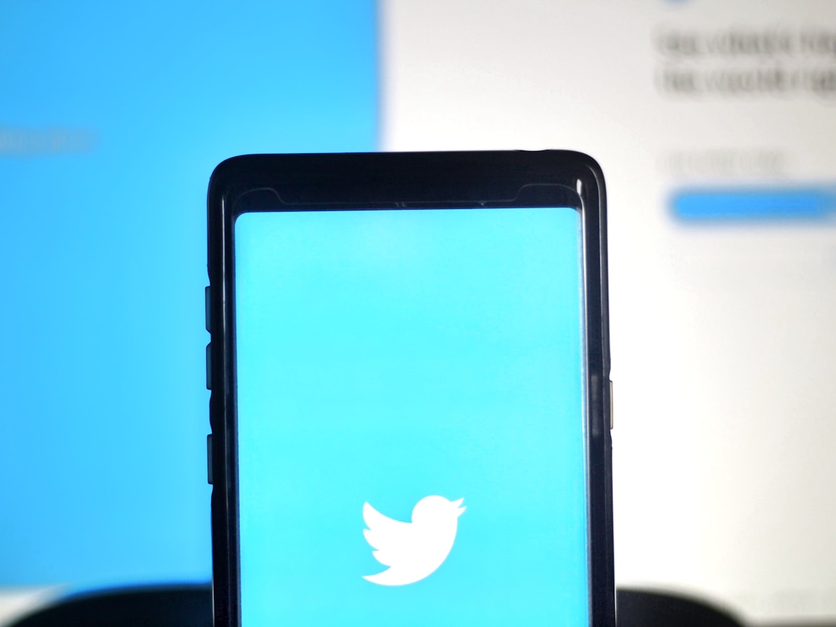 black smartphone on blue surface