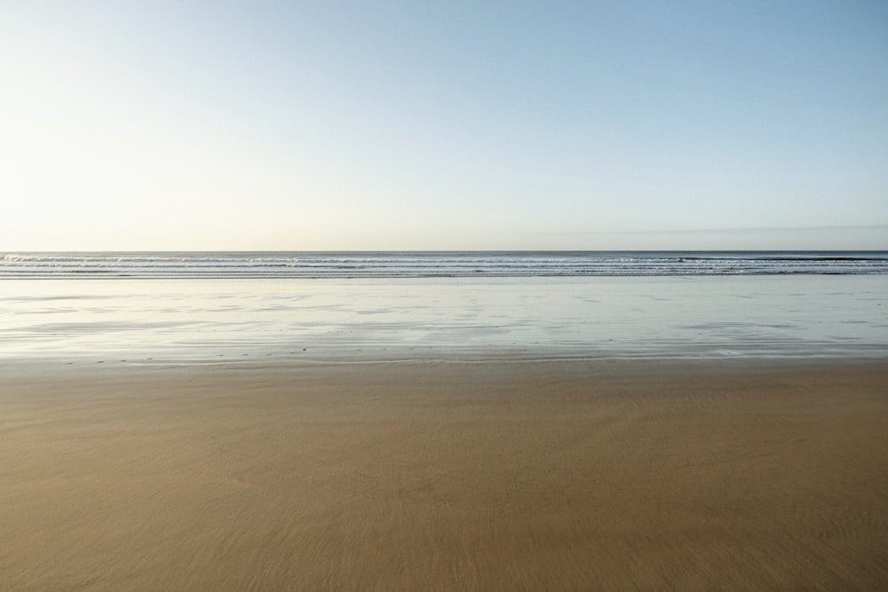 body of water under blue sky during daytime