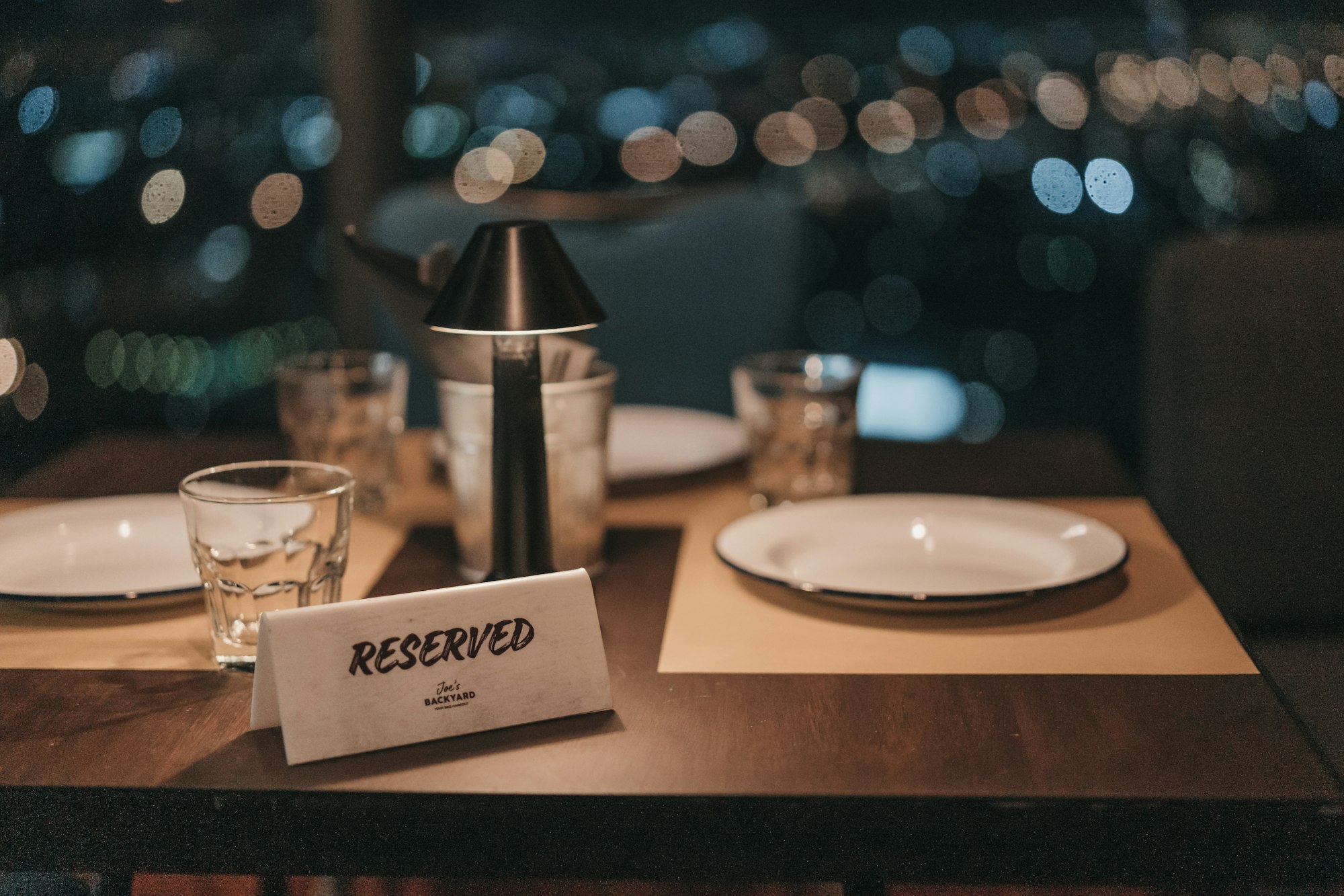 A table at a restaurant with a reserved sign on it