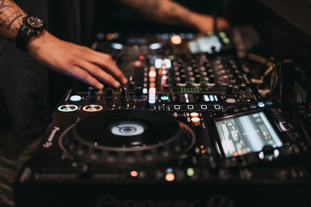 person playing dj controller in a room