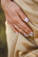 person wearing gold ring with blue stone