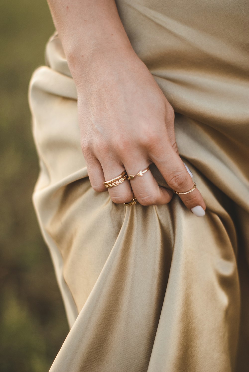 person wearing gold ring and gold ring