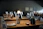 A sophisticated, warmly lit dining scene with elegant table settings and gourmet dishes.