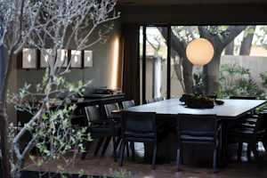 Modern pendant lamp hanging over a stylish dining table set