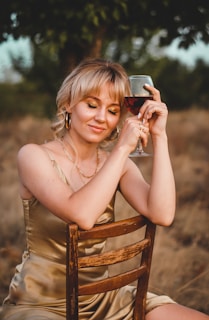 woman in white tank top holding iphone