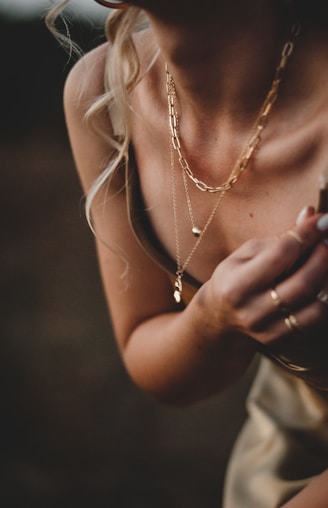 woman in white tank top wearing silver necklace