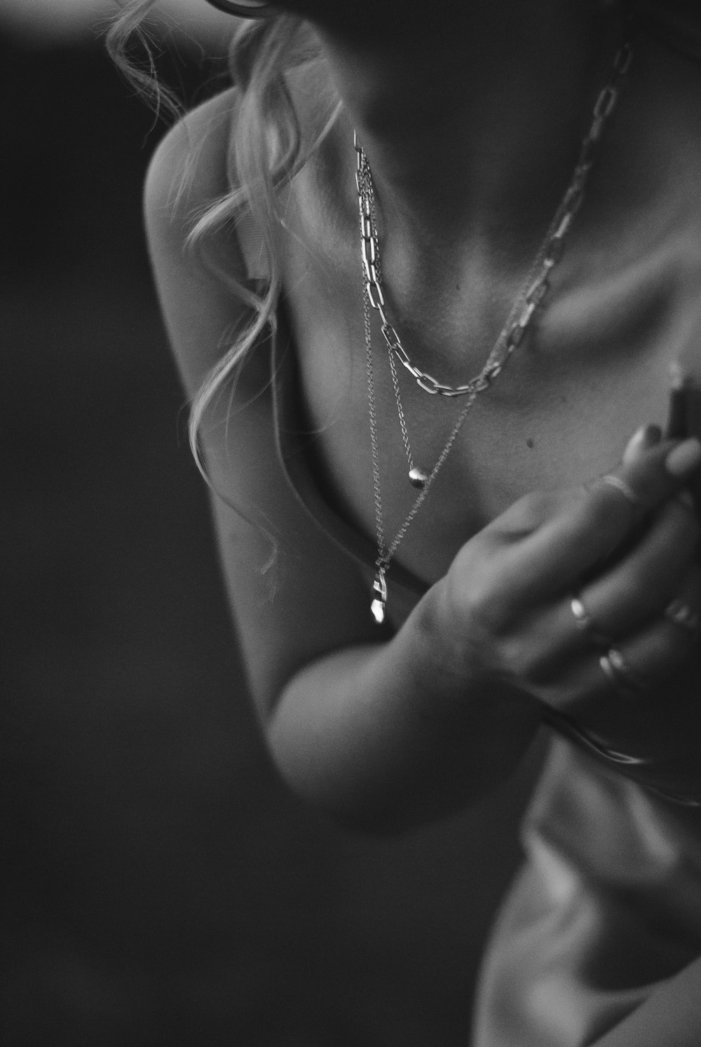grayscale photo of woman wearing necklace