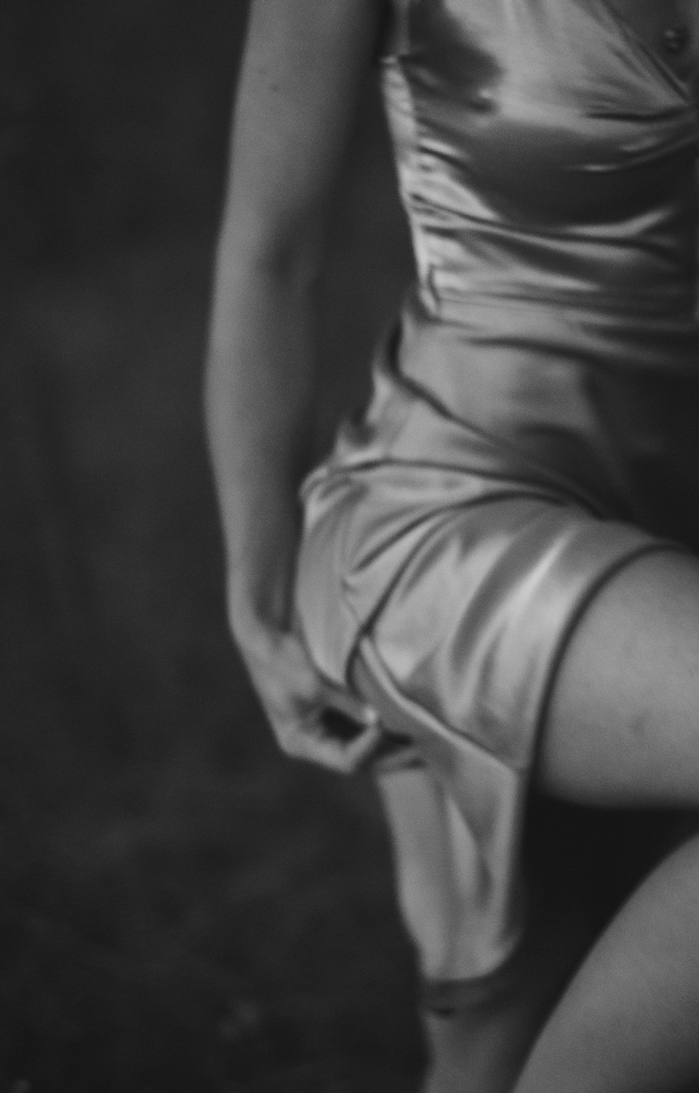 a black and white photo of a woman in a dress