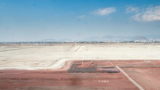 brown field under blue sky during daytime in Laguna de Texcoco Mexico