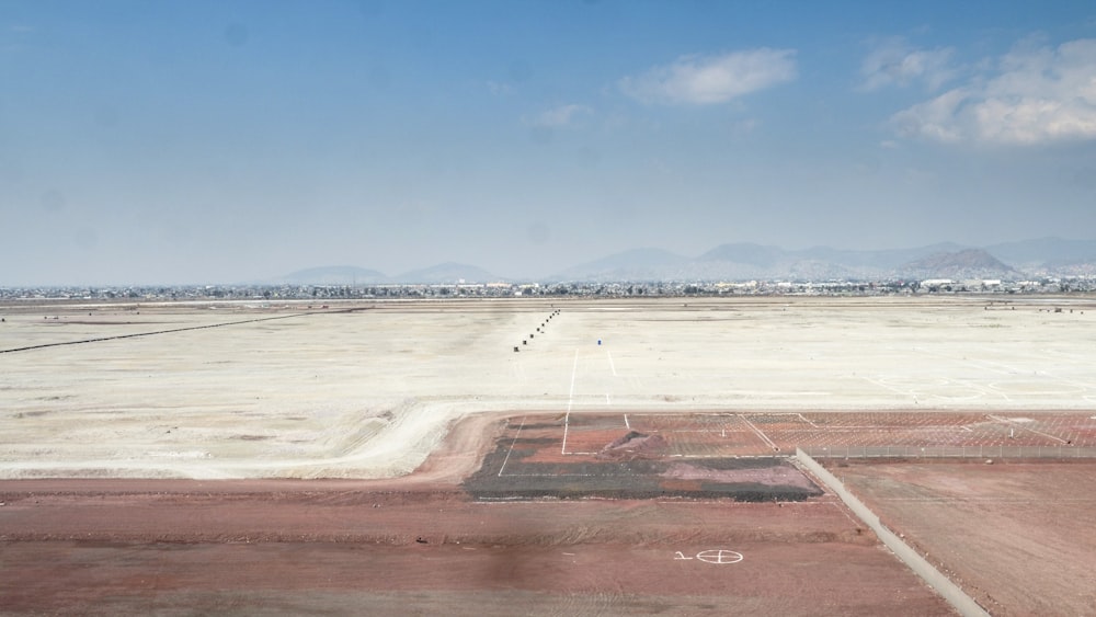 brown field under blue sky during daytime