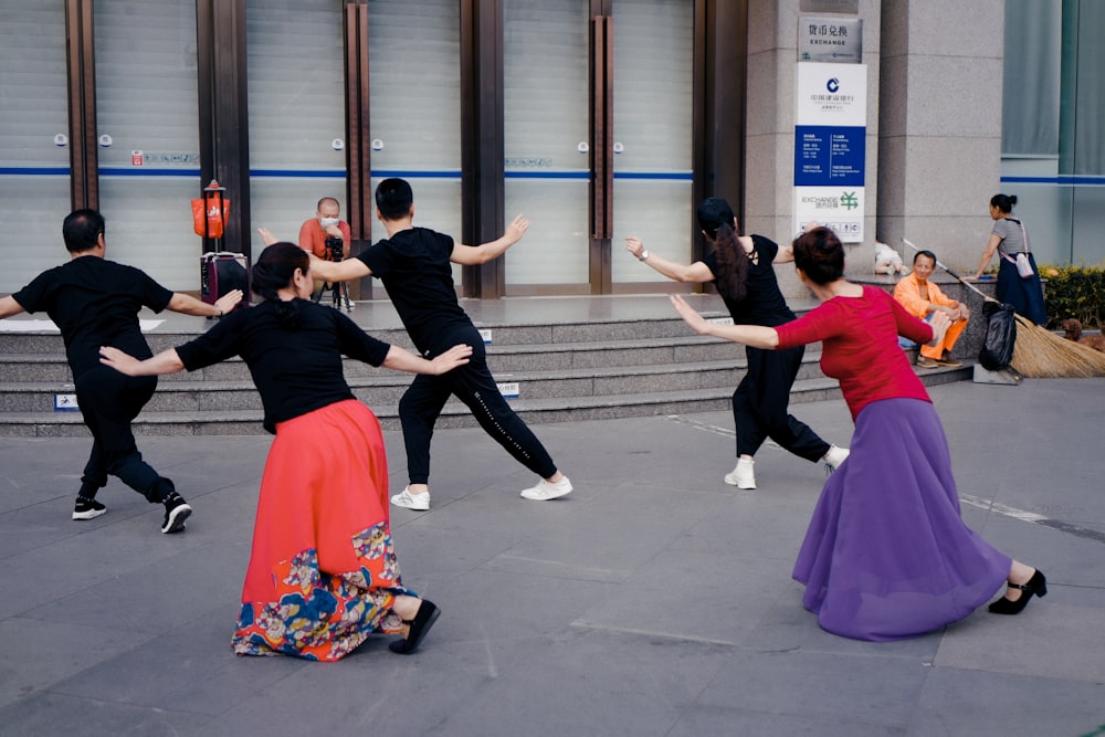 man in black shirt and pants dancing with woman in pink dress