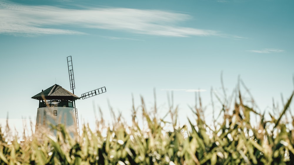 black windmill under blue sky during daytime