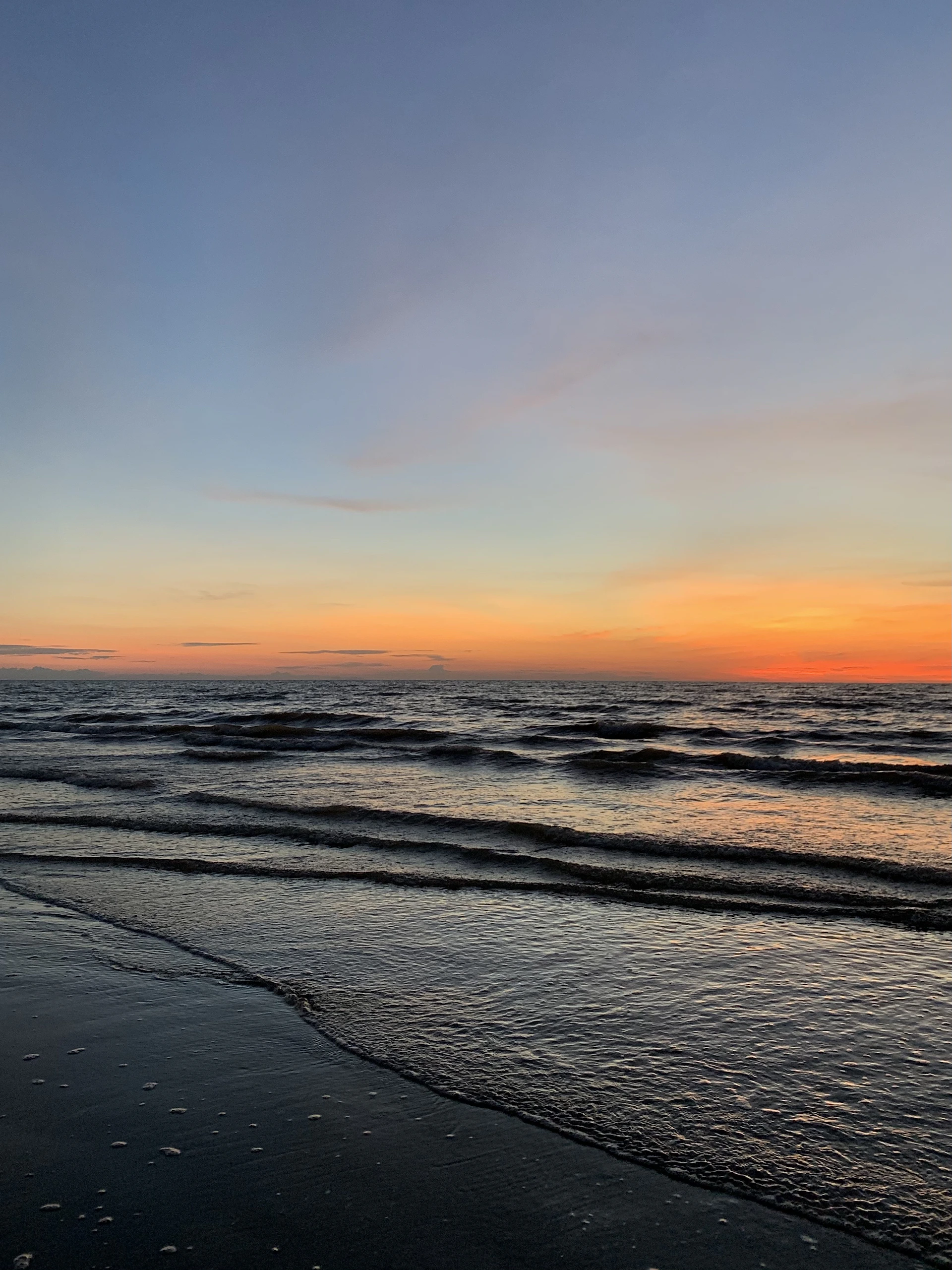 A vibrant horizontal slideshow featuring a serene beach at sunset with soft waves gently rolling in.
