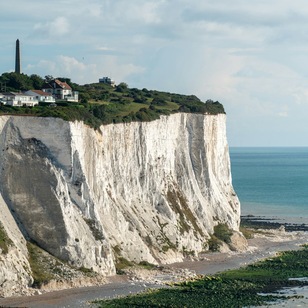 white and green cliff near sea during daytime