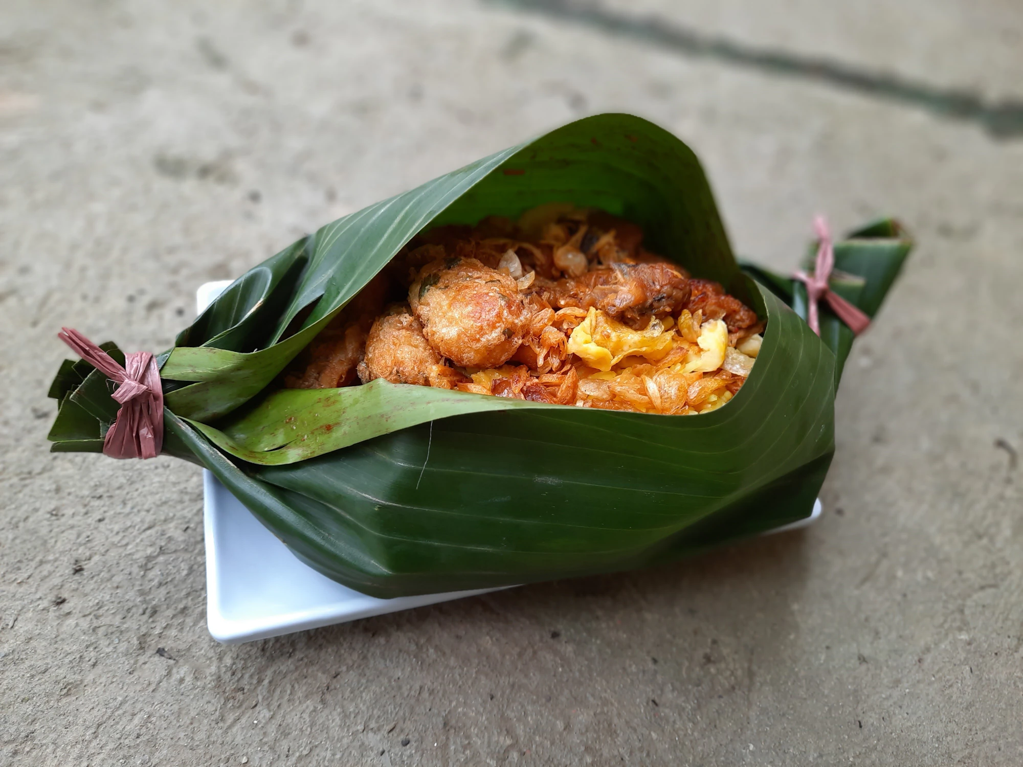 Fish Amok in banana leaf cups with coconut cream and kaffir lime