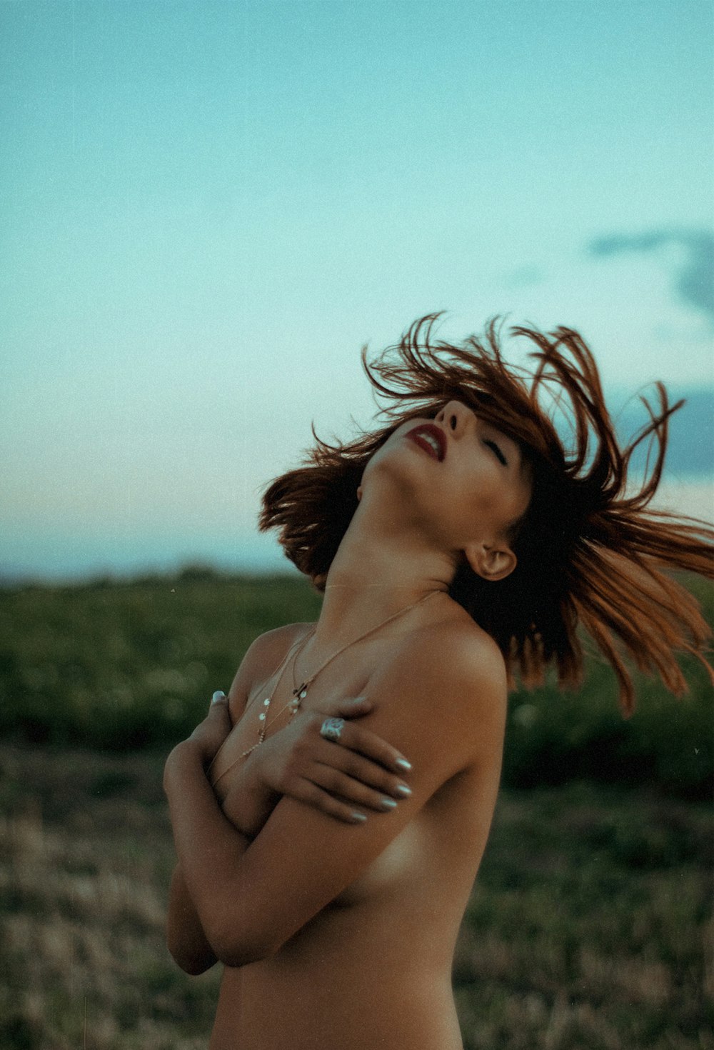 woman in brown bikini top standing on green grass field during daytime