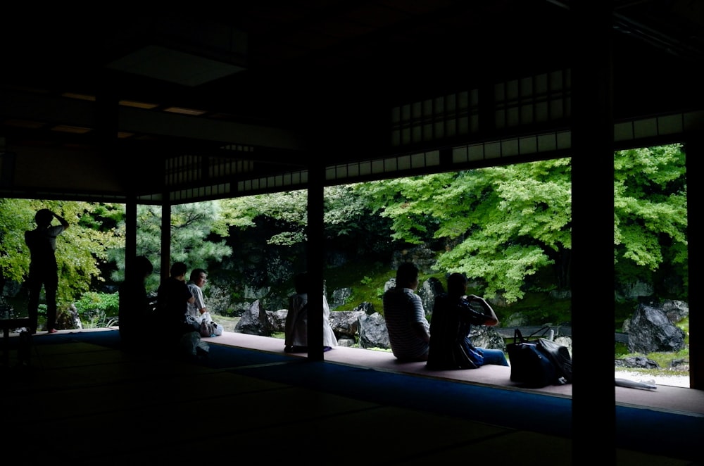 people sitting on bench near window during daytime