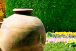 A large durable garden pot with vibrant flowers blooming in a cozy backyard setting.