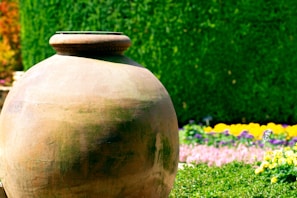 A large durable garden pot with vibrant flowers blooming in a cozy backyard setting.