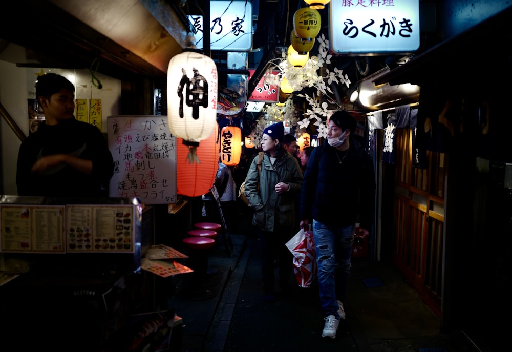 man in black jacket standing beside woman in black jacket