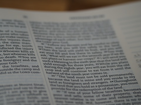 A close-up view of a page from a book featuring text written in English. The text is printed in a standard font with paragraph formatting. The page appears to have religious or formal content, as suggested by the textual arrangement and language used.