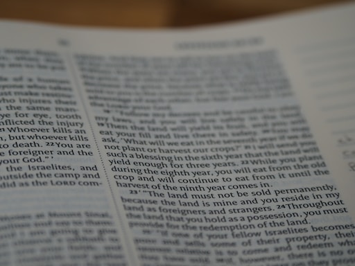 A close-up view of a page from a book featuring text written in English. The text is printed in a standard font with paragraph formatting. The page appears to have religious or formal content, as suggested by the textual arrangement and language used.