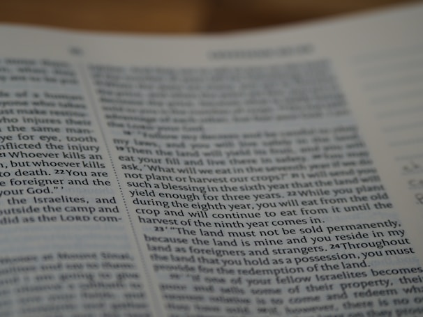 A close-up view of a page from a book featuring text written in English. The text is printed in a standard font with paragraph formatting. The page appears to have religious or formal content, as suggested by the textual arrangement and language used.