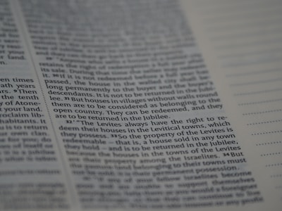 The image depicts a close-up of a page from a book, featuring text in a neat, justified layout. The text includes numbered sections and runs parallel to vertical dots on the right side.