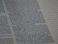 The image depicts a close-up of a page from a book, featuring text in a neat, justified layout. The text includes numbered sections and runs parallel to vertical dots on the right side.