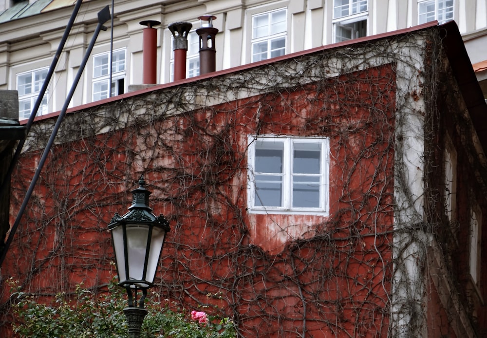 black lamp post near brown brick building