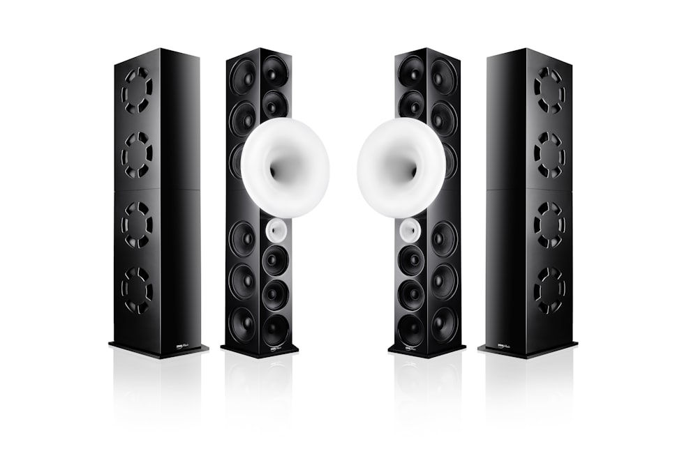 black and silver speakers on white surface