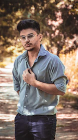 man in black dress shirt wearing black framed eyeglasses