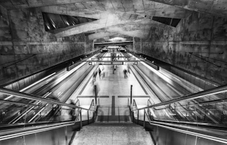 grayscale photo of a escalator