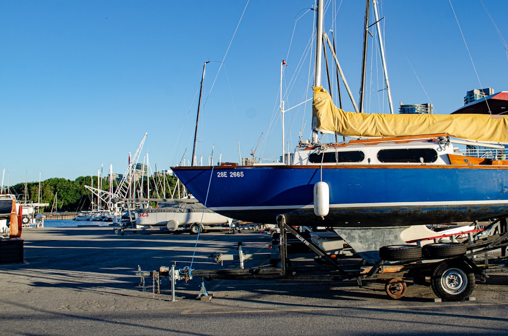 blue and white boat on dock during daytime