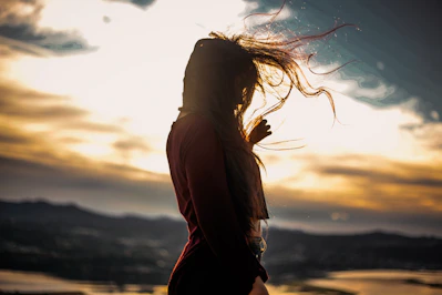 woman in brown long sleeve shirt standing during daytime
