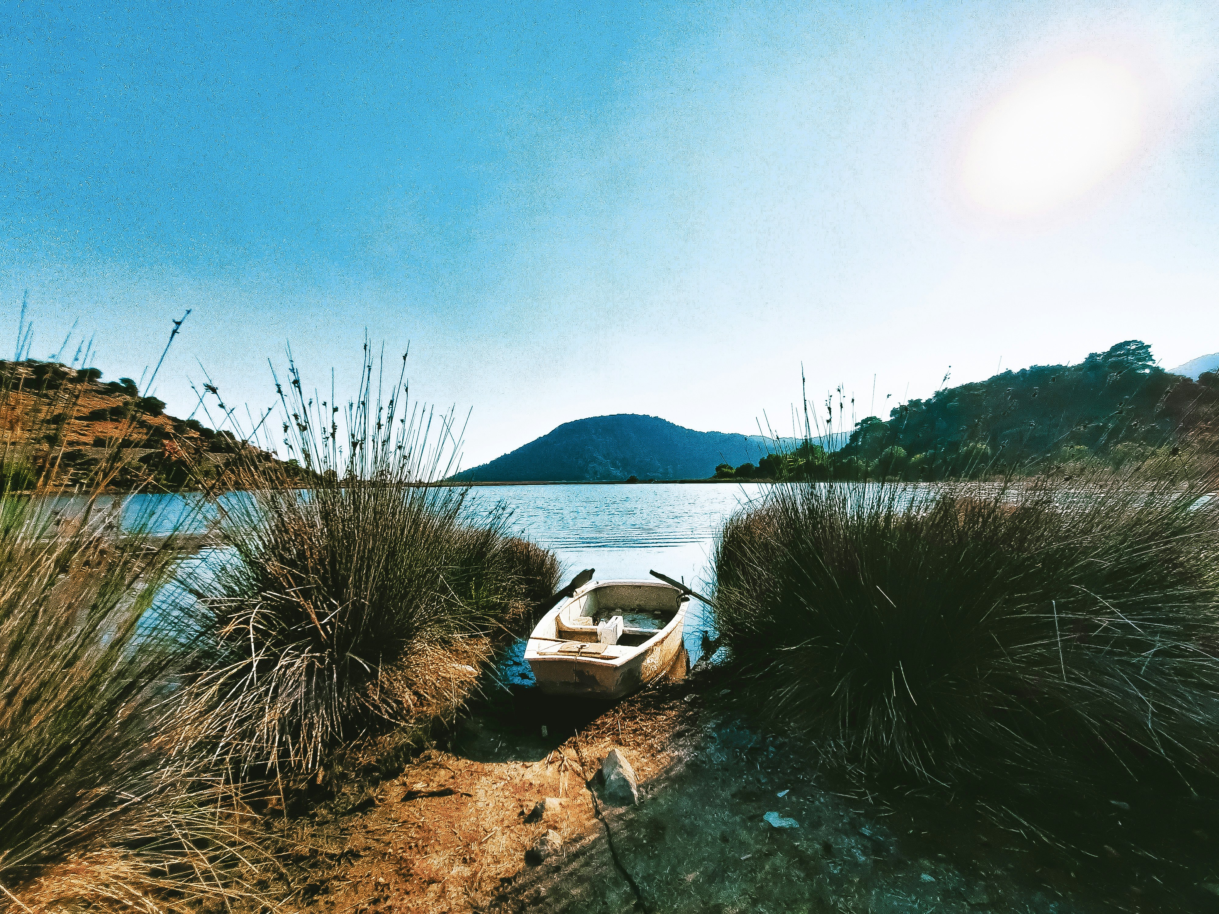 white and brown boat on body of water during daytime