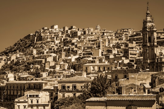 white and brown concrete buildings during daytime in Modica Italy