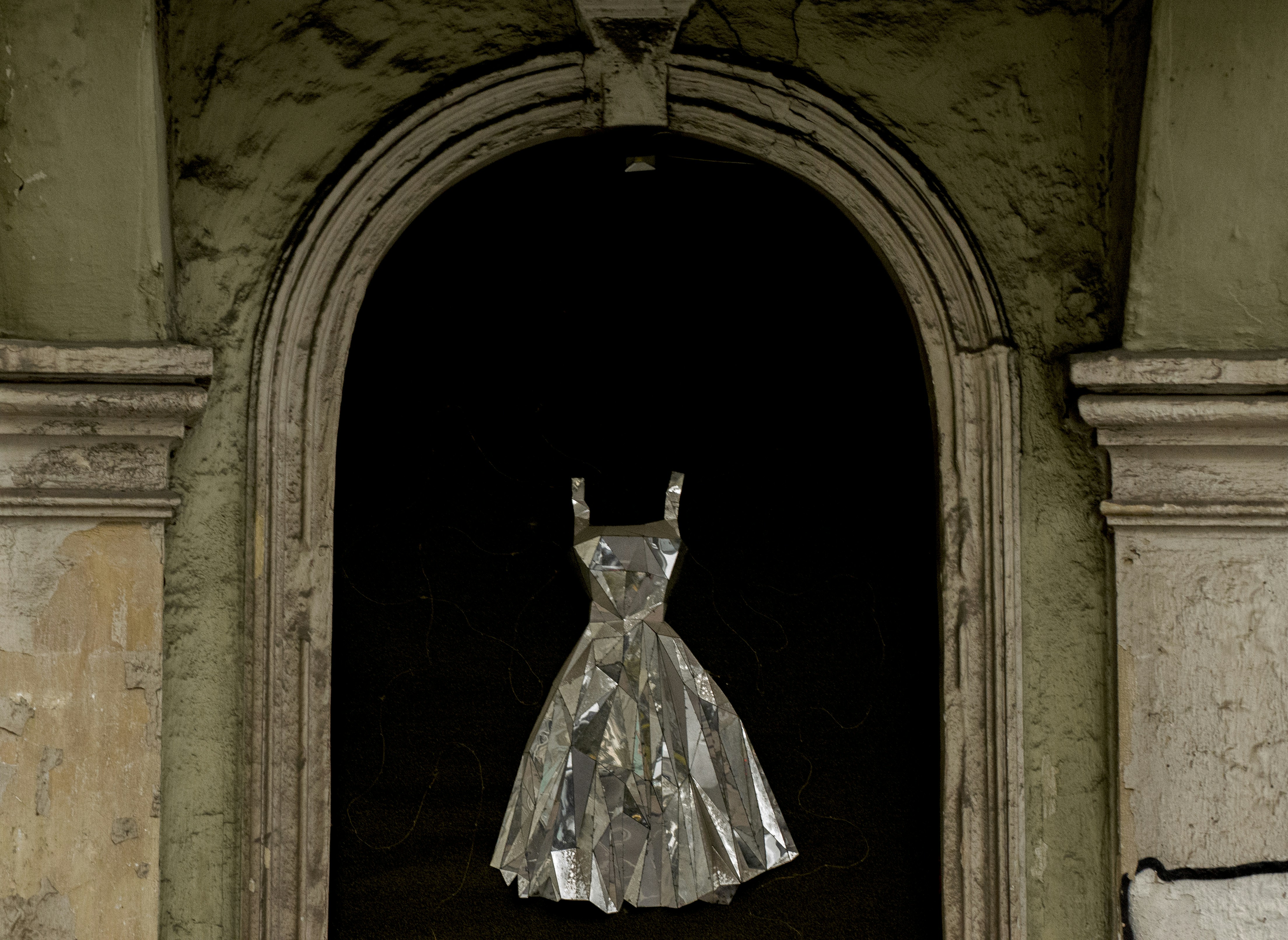 woman in white dress standing on door