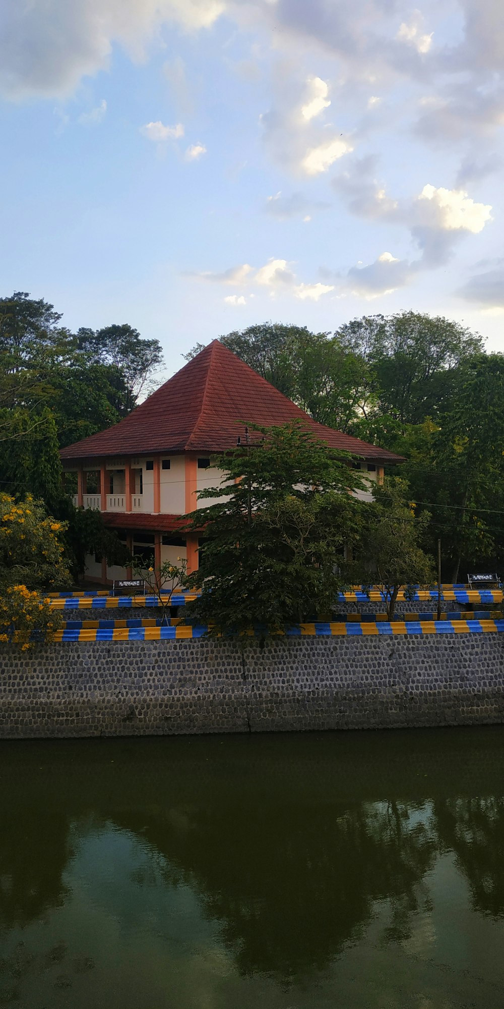 brown and white house surrounded by trees