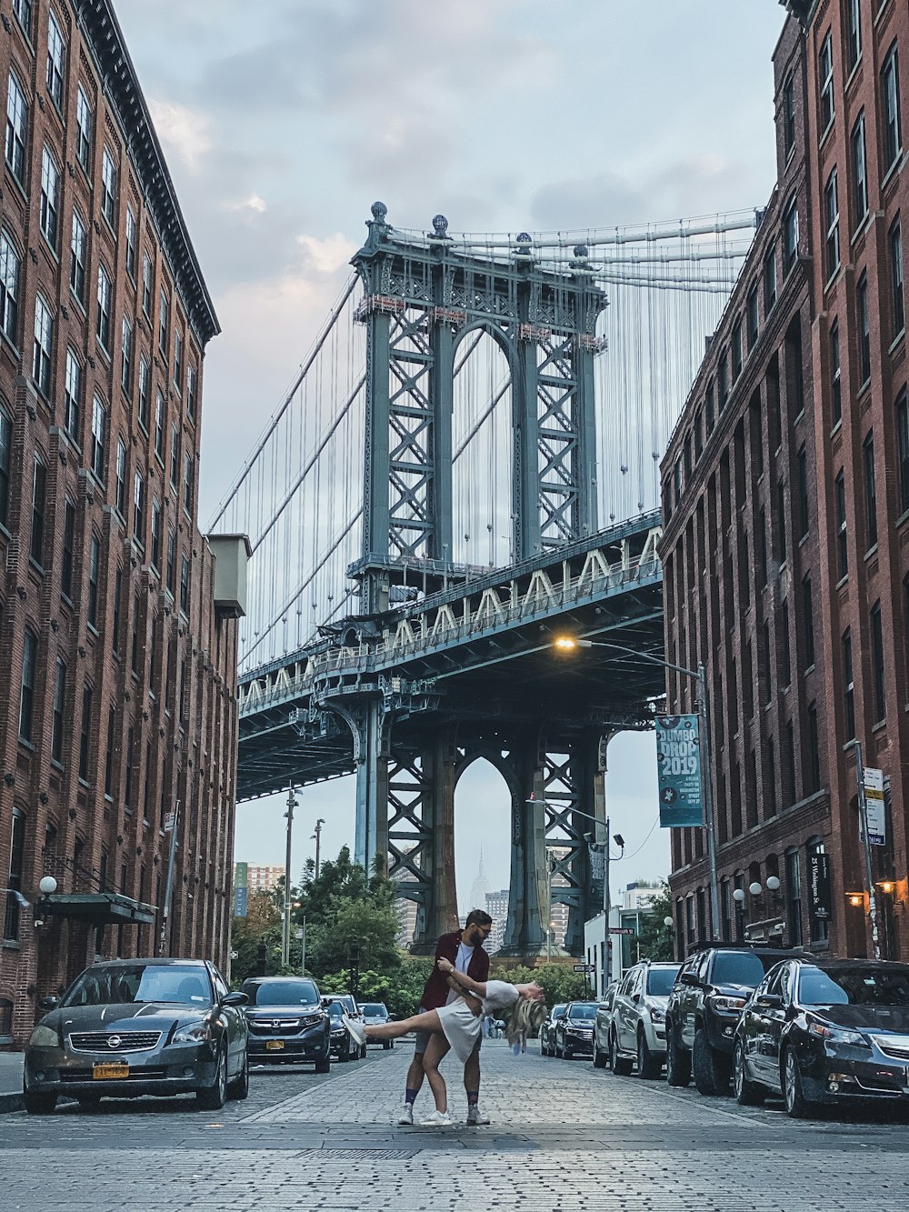 people walking on street near bridge during daytime