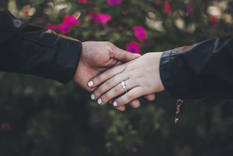 person in black long sleeve shirt with gold ring